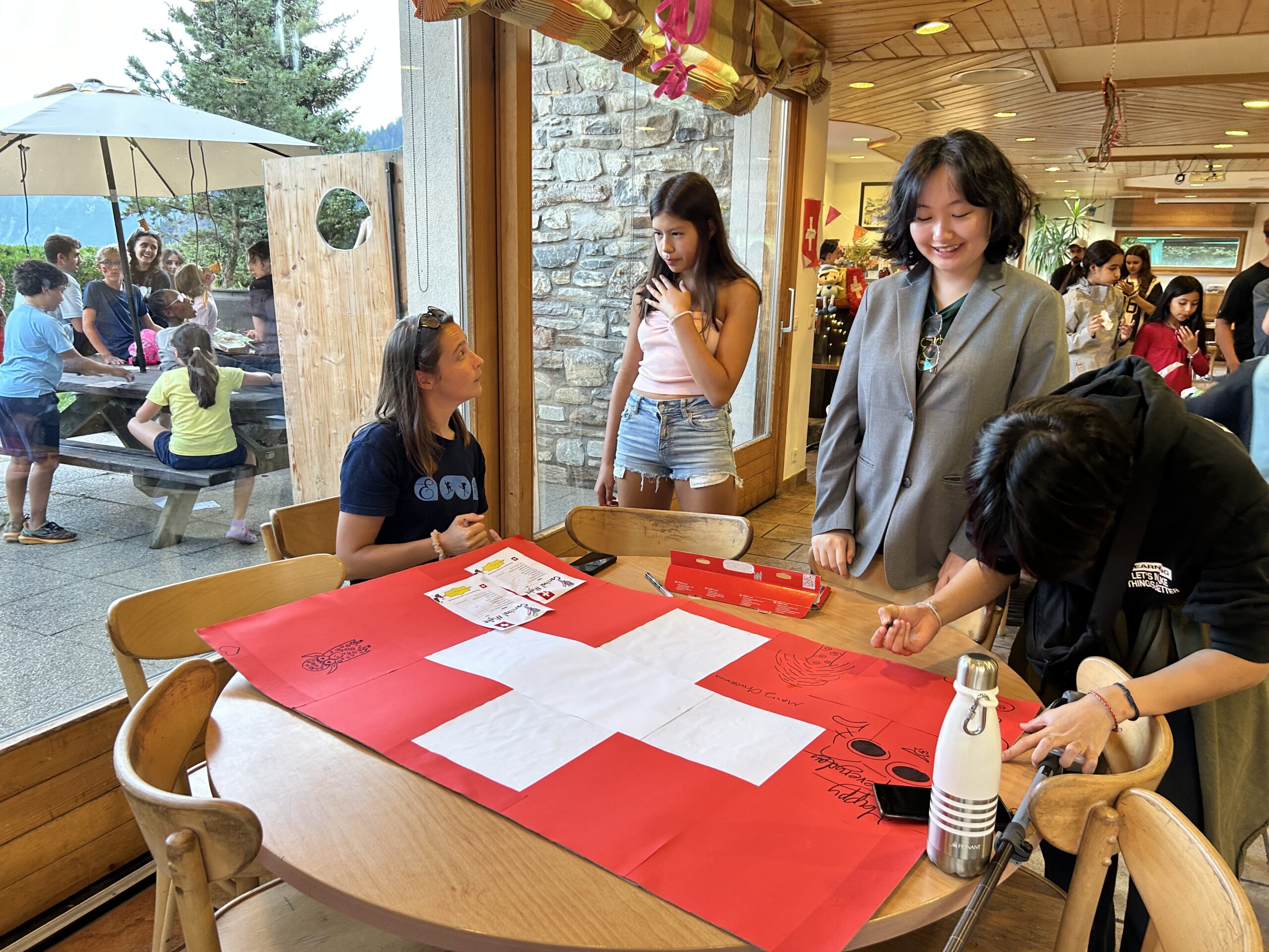 Students interacting with each other with a Swiss flag