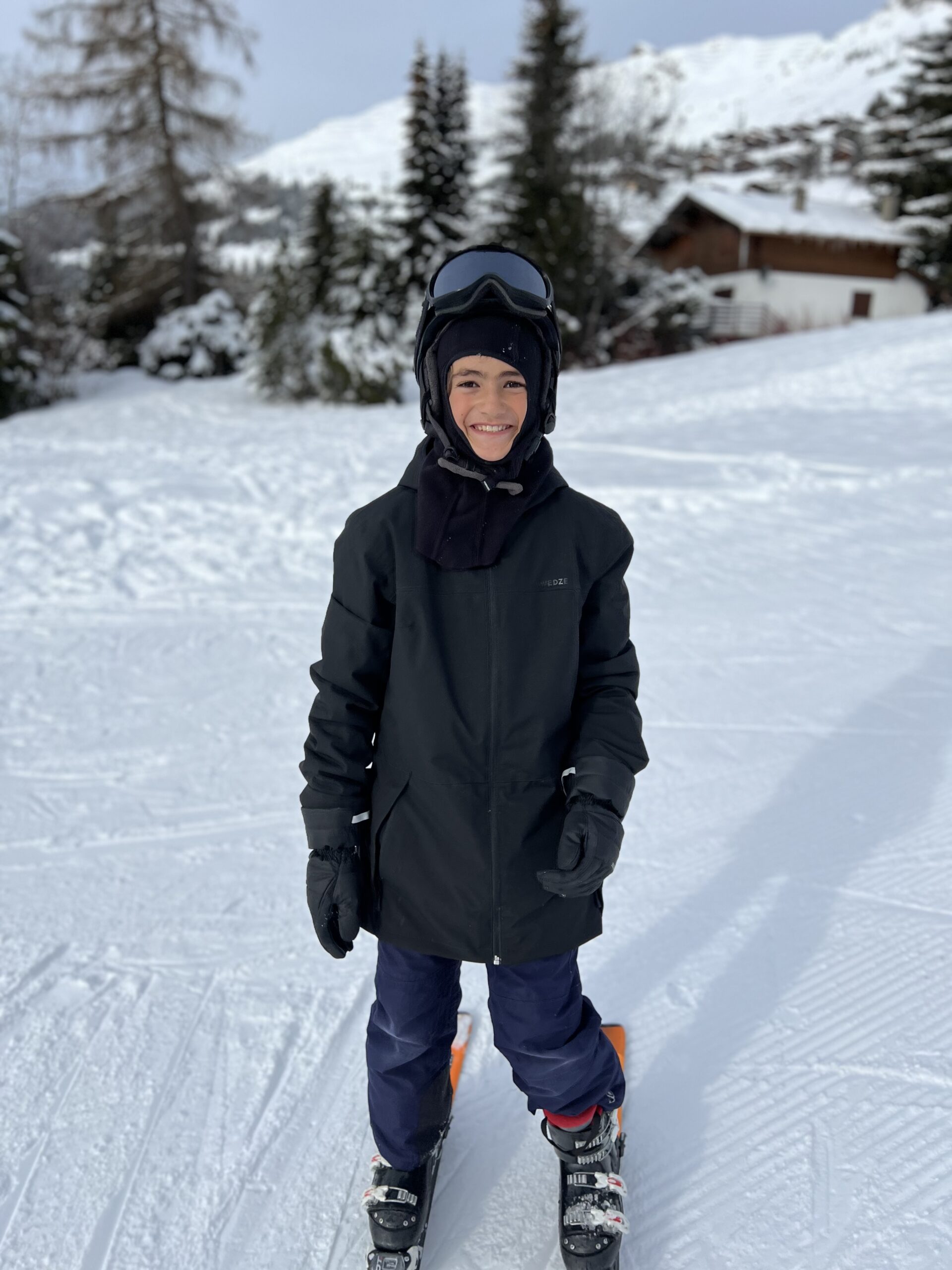 Boy dressed in winter clothes for skiing