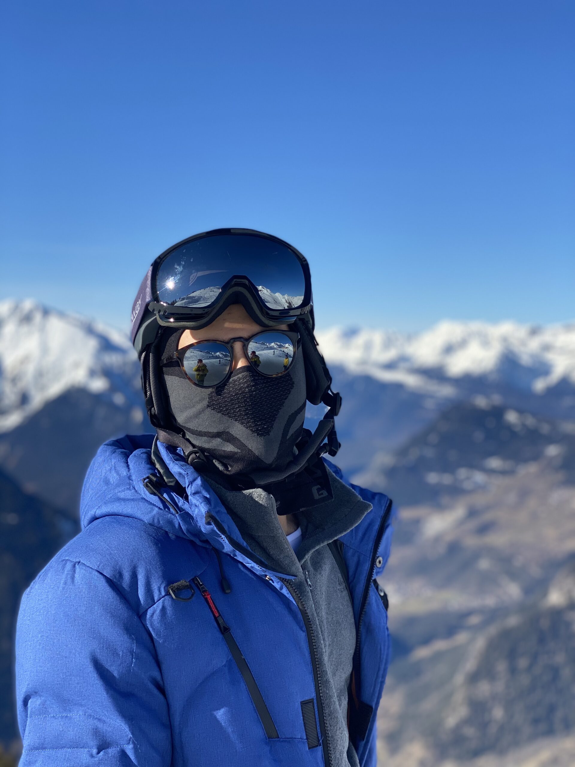 Boy covering his face for skiing in the mountain