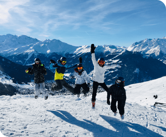5 teenagers jumping in the air during their winter ski camp in Les Elfes International, located in Verbier, Switzerland, Europe