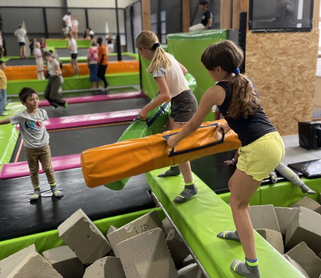 Group of children playing in a trampoline park at Les Elfes international summer camp 2024 in Verbier, Switzerland