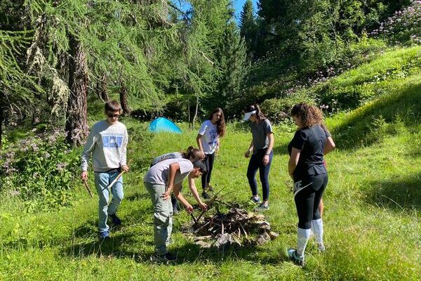 children setting up campsite and fireplace for their Bronze duke of edinburgh expedition with Les Elfes International in Switzerland