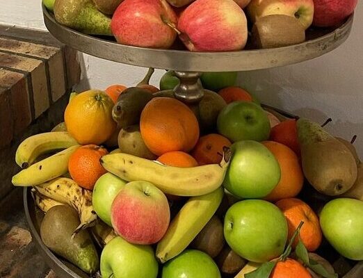 Basket of fresh fruits including bananas, apples, oranges, pears and kiwis available for kids and teens to eat any time during their 2024 summer camp experience at Les Elfes International in Verbier, Europe
