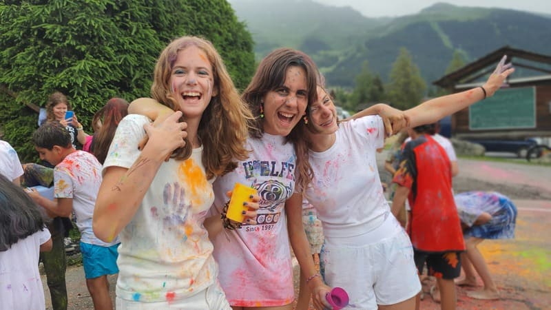 group of 3 girls laughing full of colors during the 2024 summer camp at les elfes international in Europe